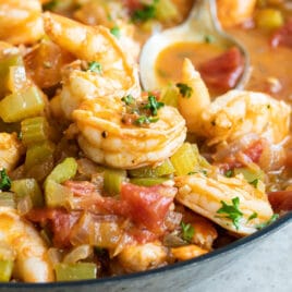 Shrimp creole in a black bowl.