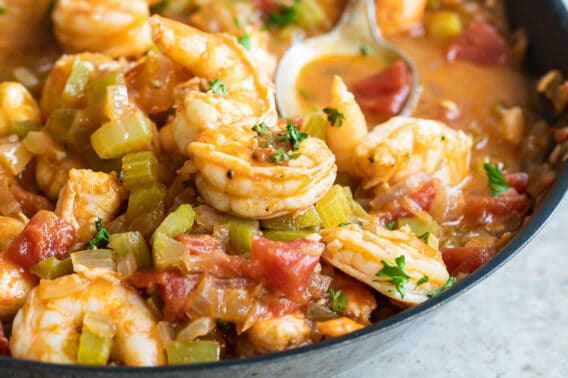 Shrimp creole in a black bowl.
