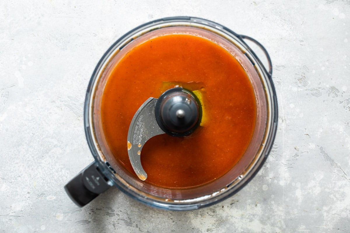 A food processor with homemade French dressing in it.