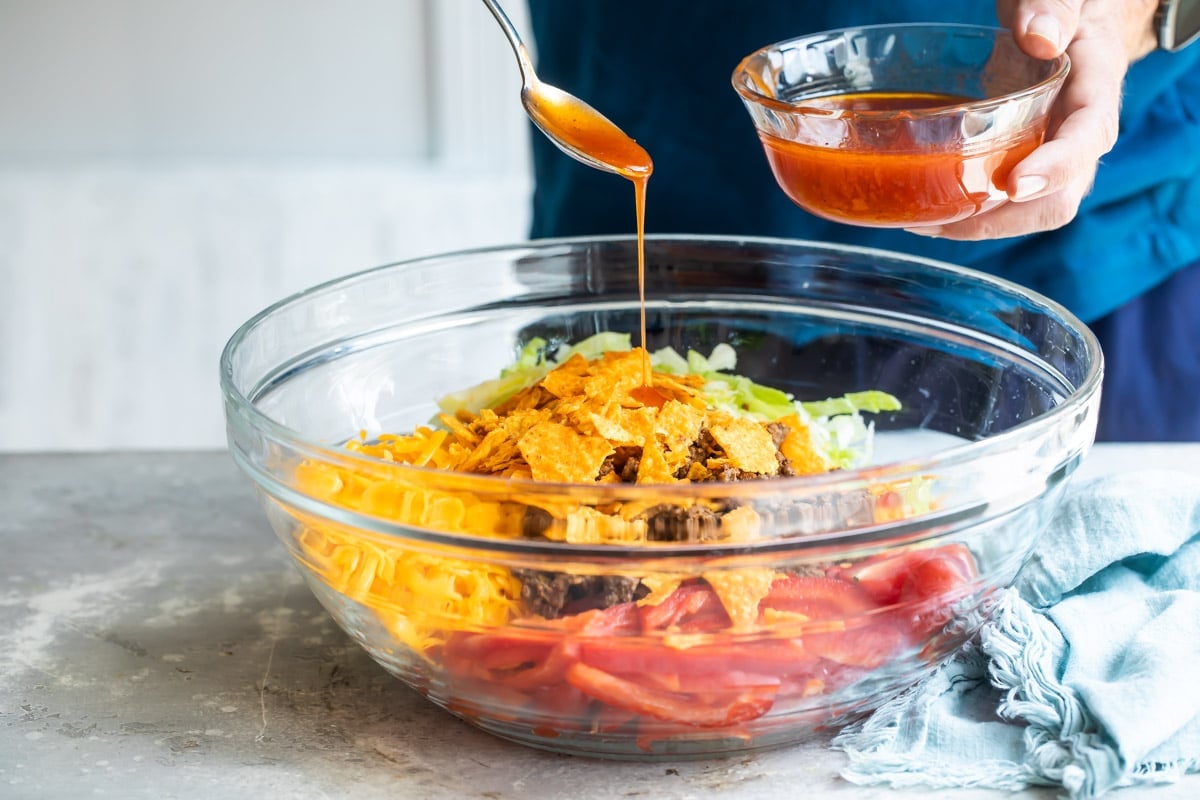 A clear bowl filled with Dorito Taco Salad.