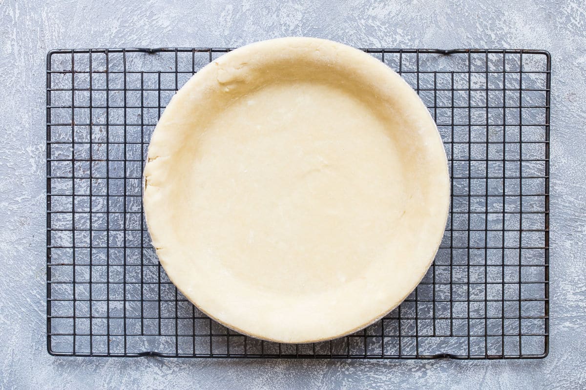 A pie crust fit into a pie plate.