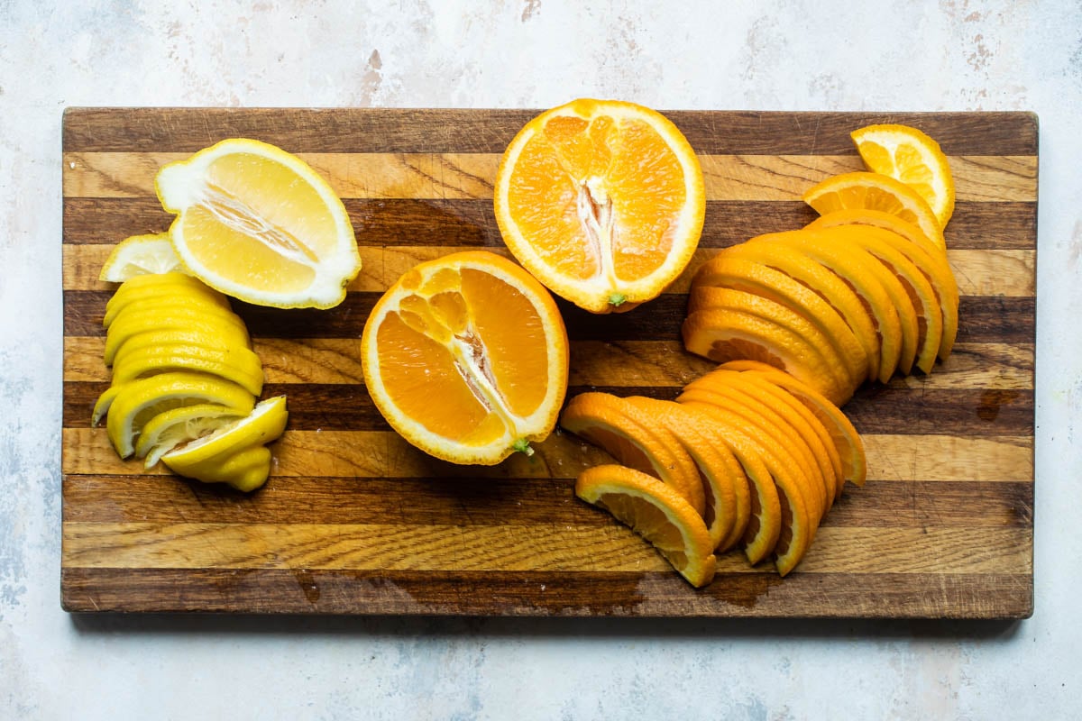 Oranges and lemons sliced into half moons for orange marmalade.