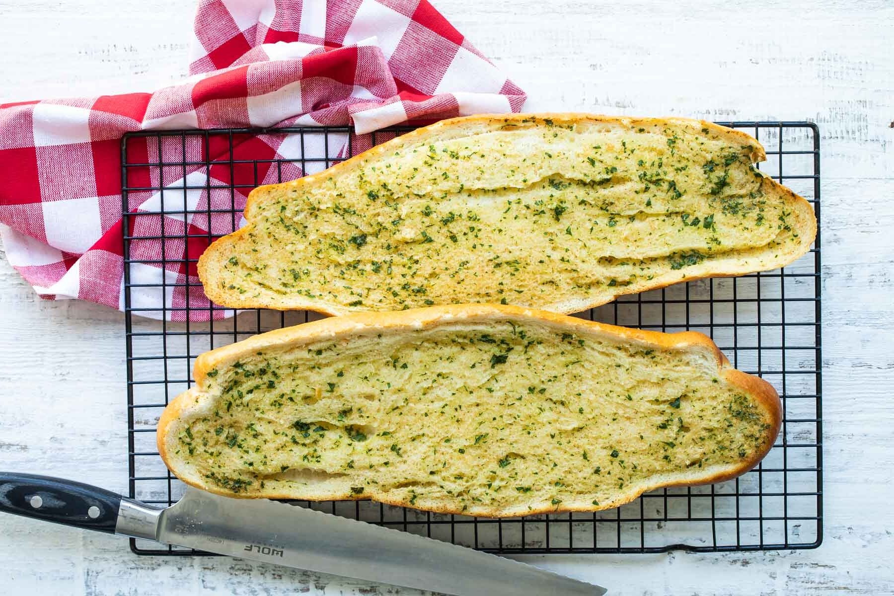 Garlic bread on a cooling rack.