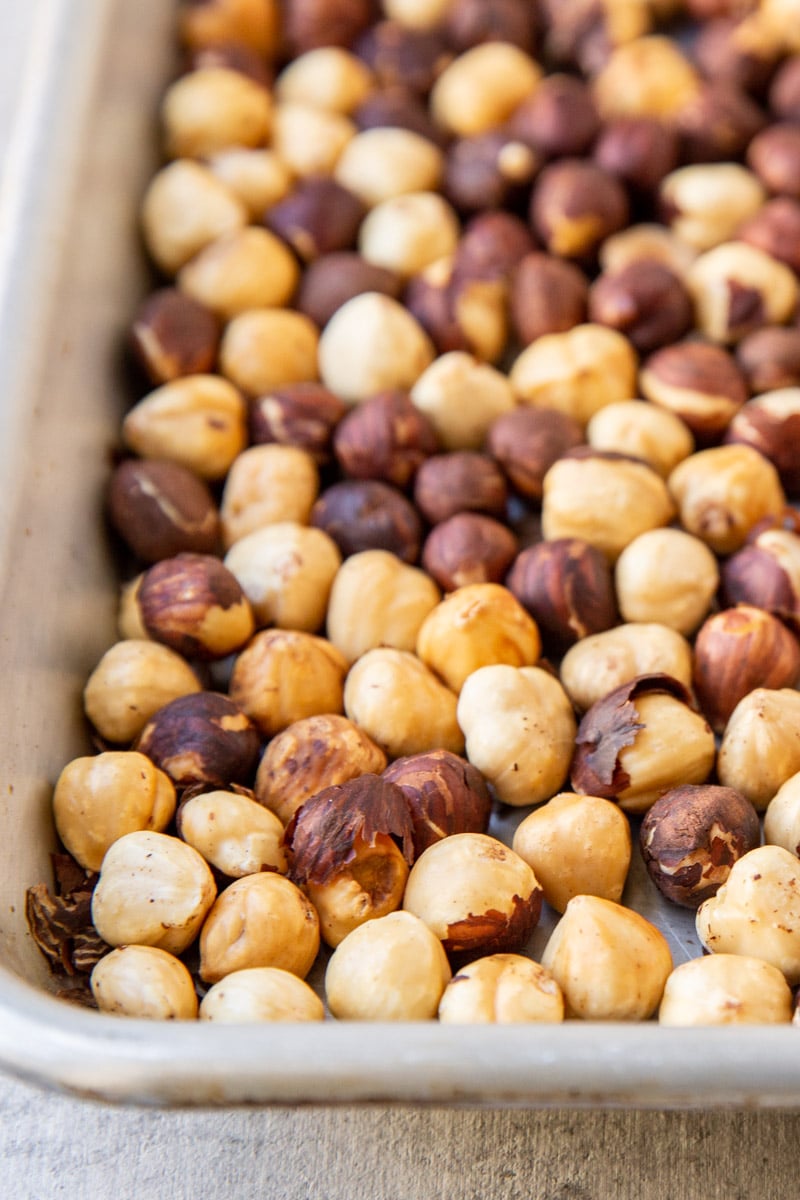 Hazelnuts roasted on a baking sheet.