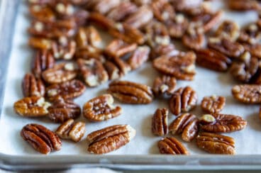 Toasted pecans on a baking sheet.