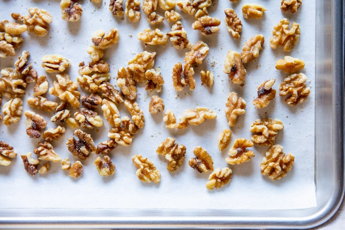 Toasted walnuts on a baking sheet.