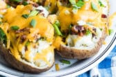 Twice baked potatoes on a white platter.