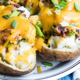 Twice baked potatoes on a white platter.