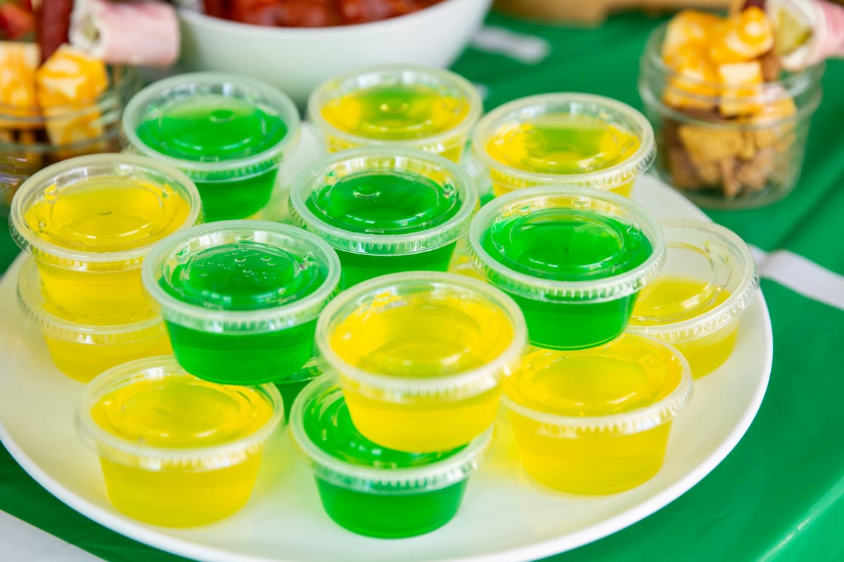 A tray of lemon and lime Jello shots for a football party.
