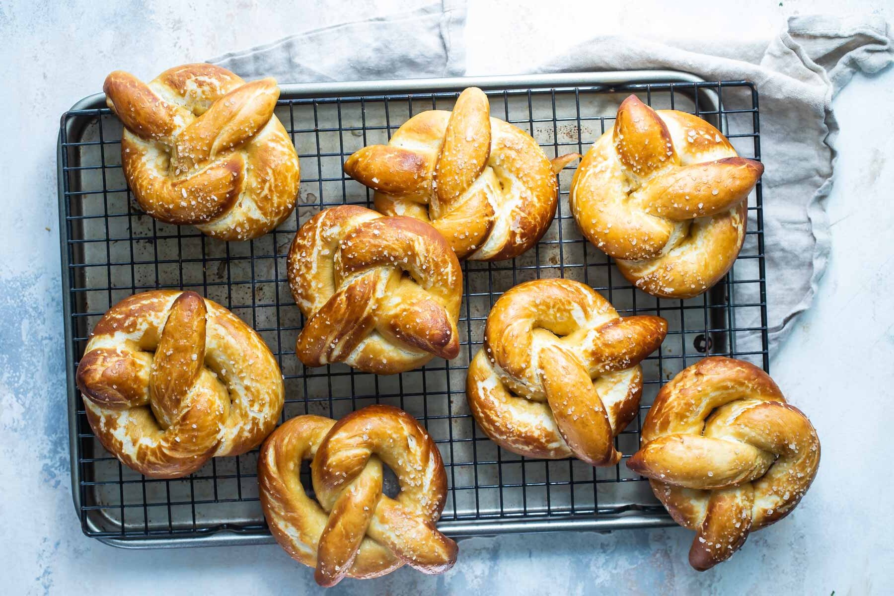 Homemade soft pretzels on a cooling rack.