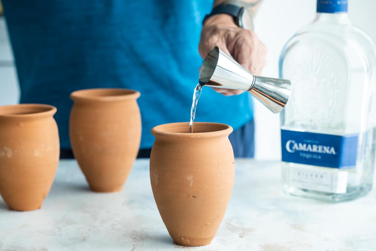 Making a cantarito cocktail in a clay cup.