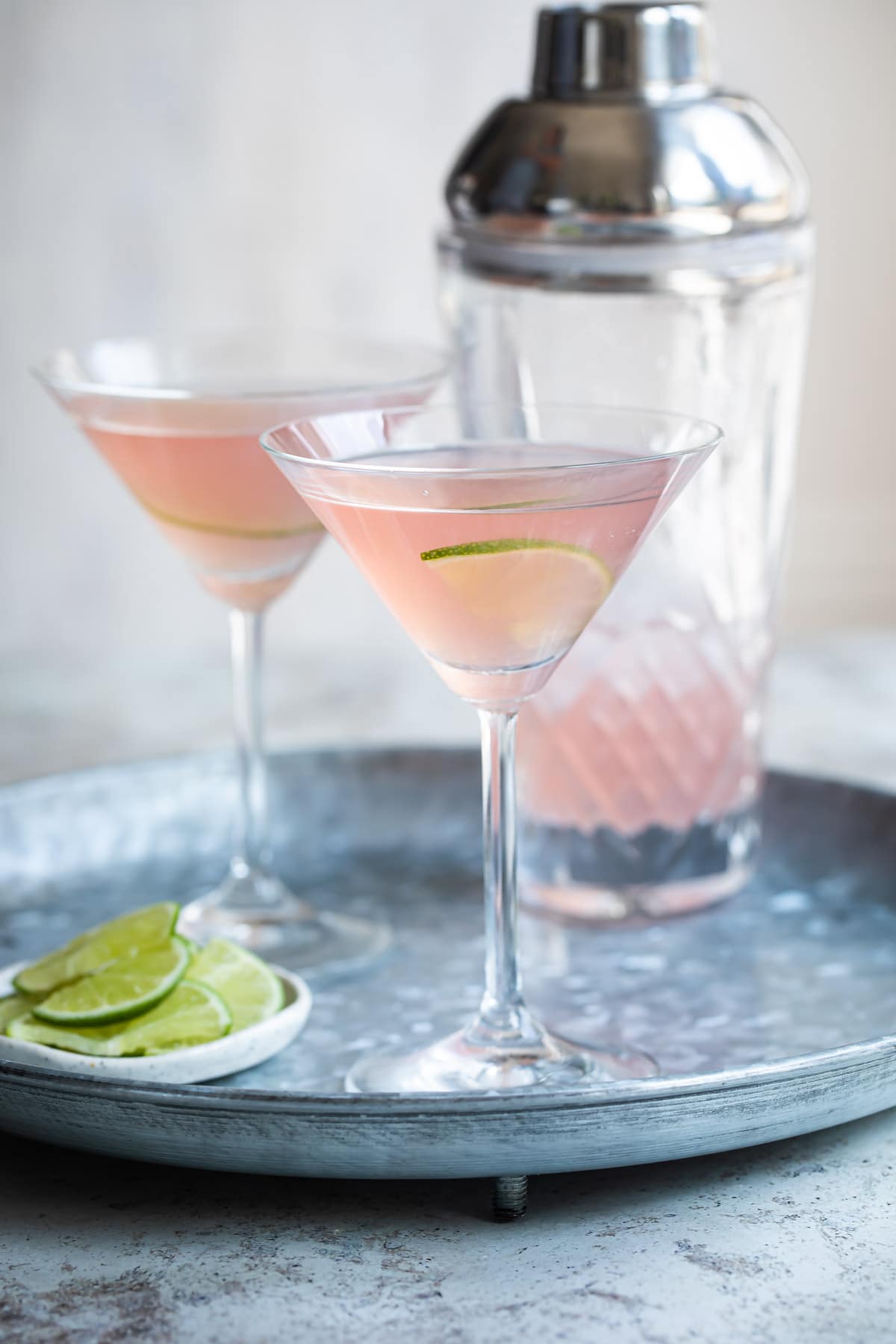 Two cosmopolitan cocktails on a tray.