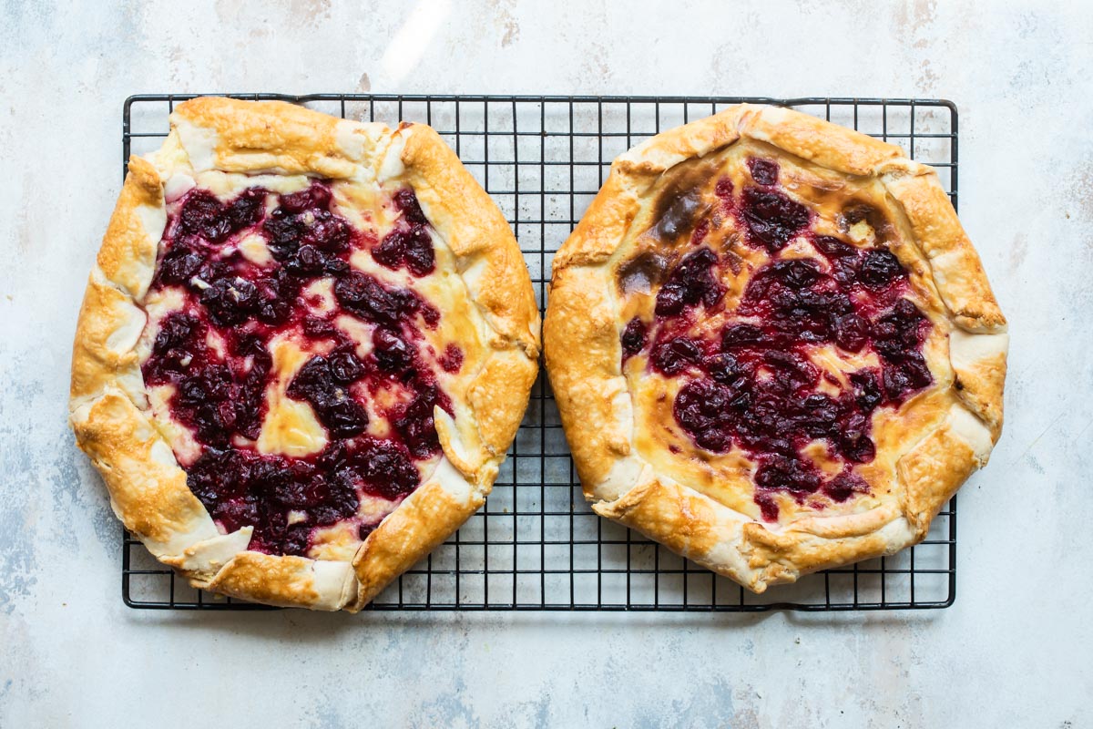 Two cranberry cheesecake galettes resting on a cooling rack.