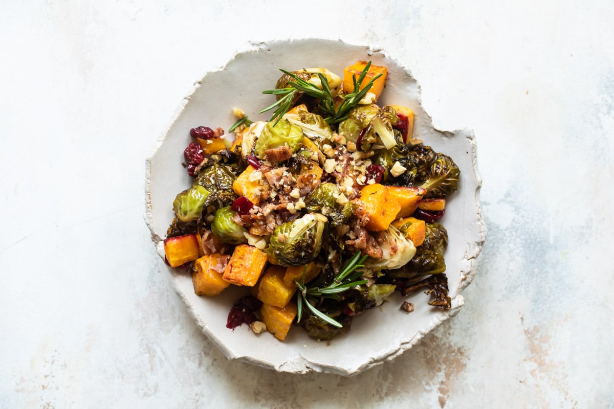 A serving of harvest roasted vegetables on a white plate.
