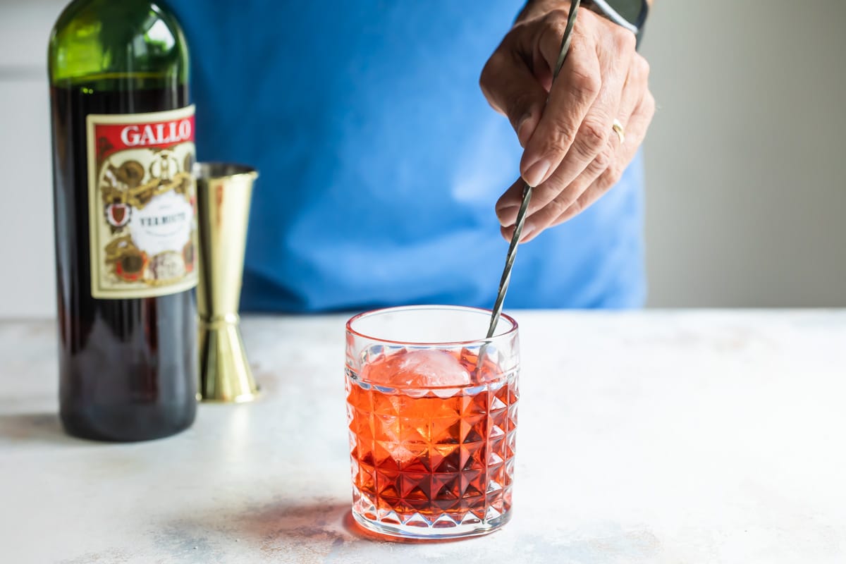 Making a negroni cocktail in a rocks glass.