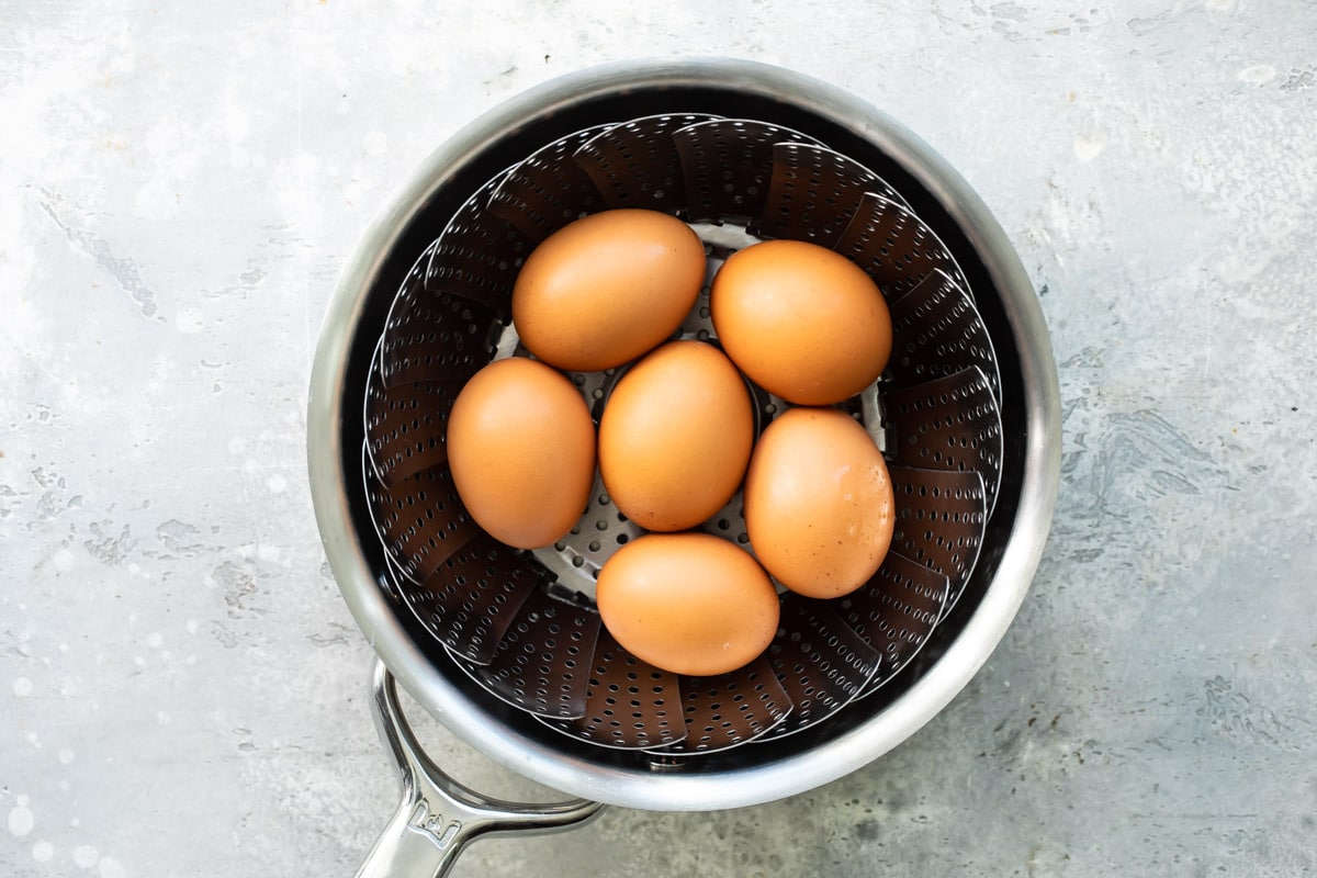 Cooking hard-boiled eggs in a saucepan.