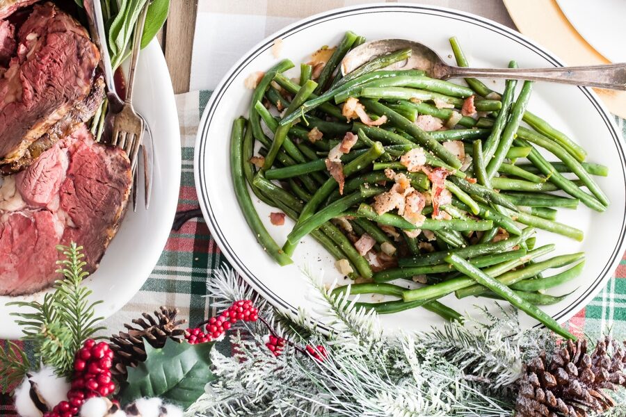 This recipe for Green Beans with Bacon has many names: Texas Roadhouse Green Beans, Southern Style Green Beans, or Arkansas Green Beans, to name just a few. I make mine with fresh green beans and just the right amount of brown sugar for a little extra flavor.