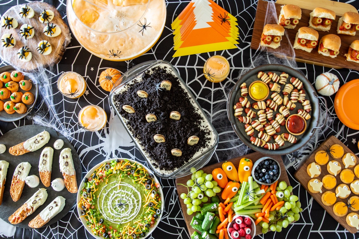 A table filled with Halloween party inspired versions of everyday recipes.