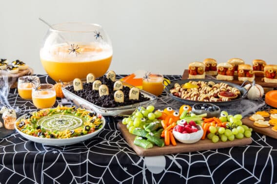 A table filled with Halloween party inspired versions of everyday recipes.