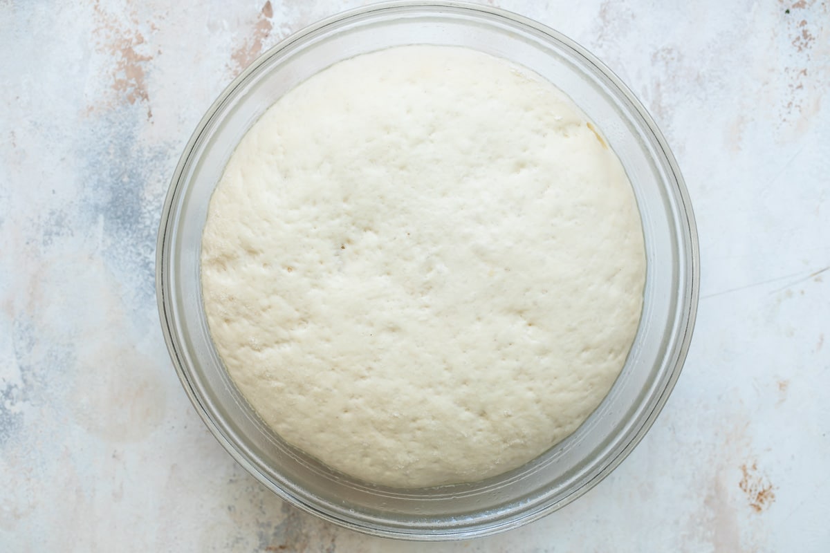 A bowl of crescent roll dough after rising.