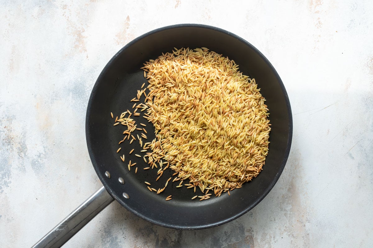 Orzo pasta in a skillet.