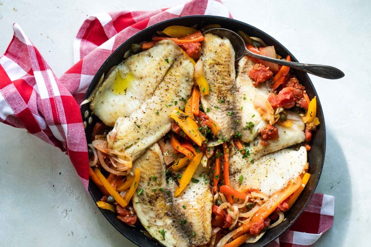 Pan fried tilapia in a skillet.