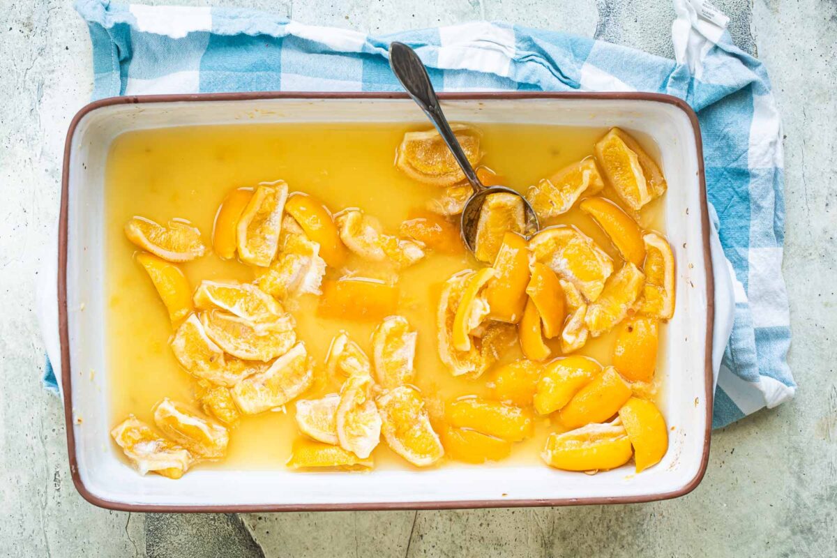 Preserved lemons in a casserole dish with a spoon.