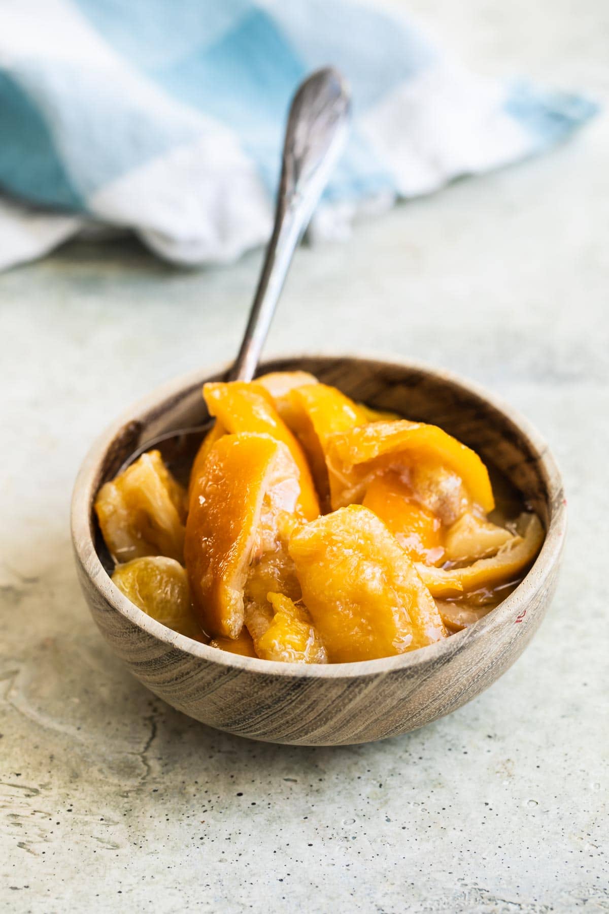 Preserved lemons in a bowl with a spoon.