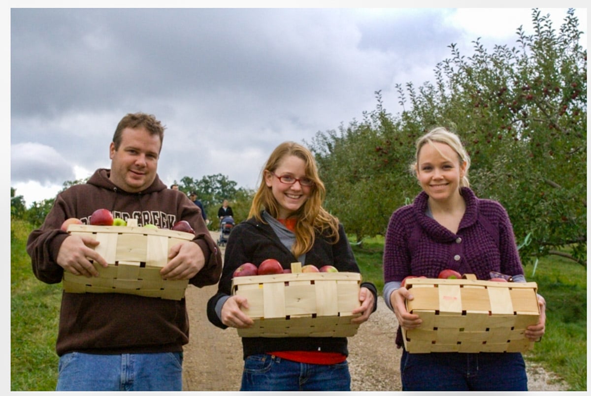Meggan Hill picking apples in an orchard with her brother and sister in 2009.