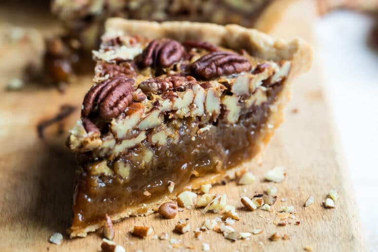 Slices of pecan pie on a board.