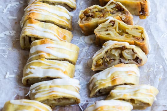 Two apple strudels on a baking sheet.
