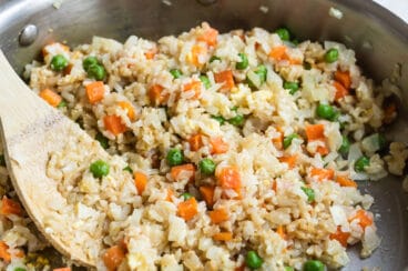 Brown fried rice in a silver skillet.
