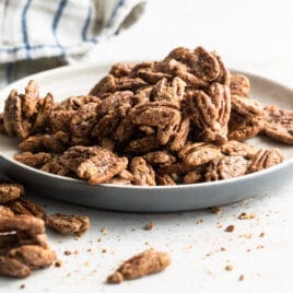 Candied Pecans on a gray plate.