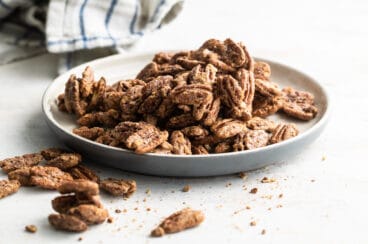 Candied Pecans on a gray plate.