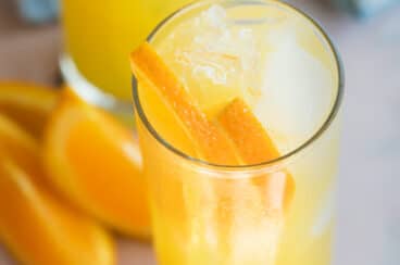 A fuzzy navel with ice and orange slices.