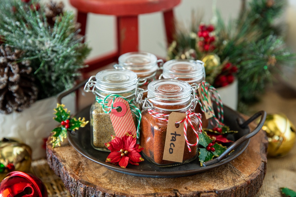 Small bottles of homemade spice blends tied with Christmas twine for gift-giving.