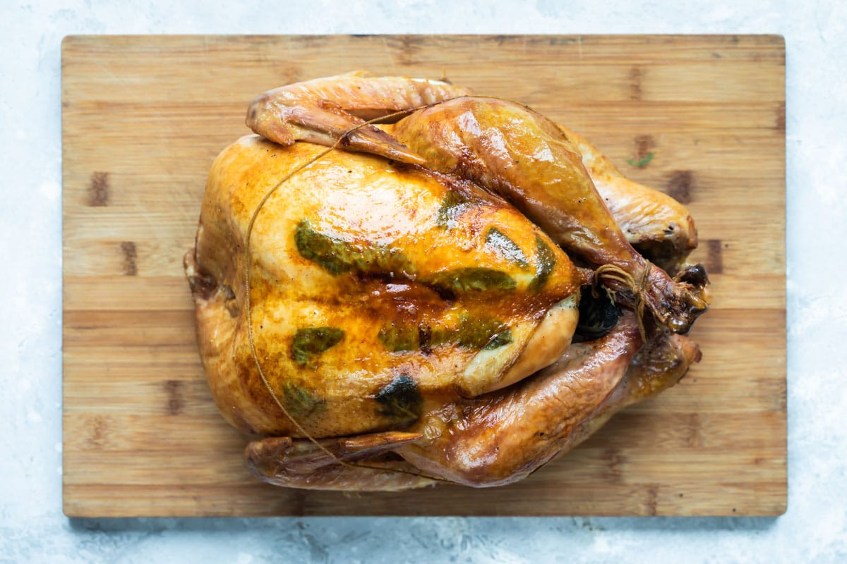 A roasted turkey on a cutting board.
