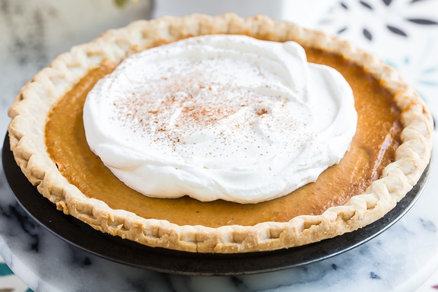 Make ahead pumpkin pie topped with whipped cream.