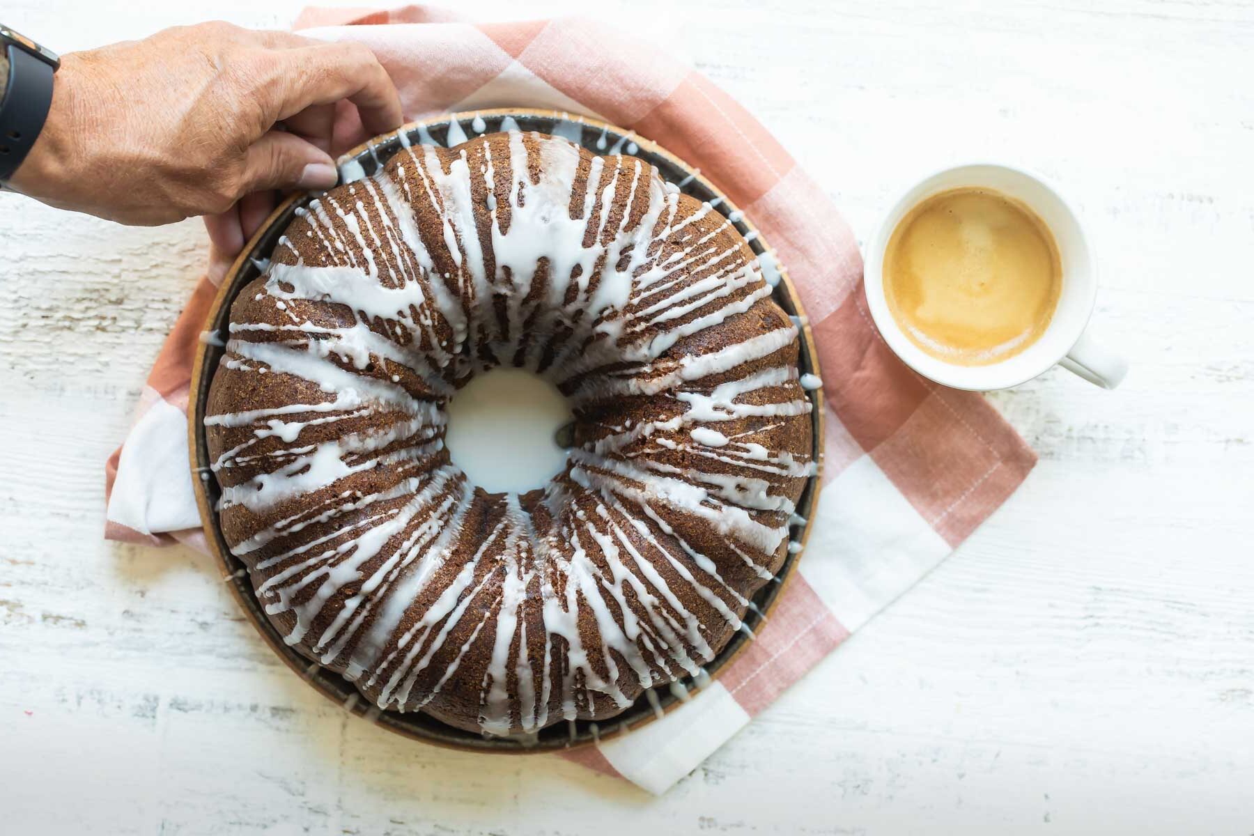 A round spice cake with drizzled icing.