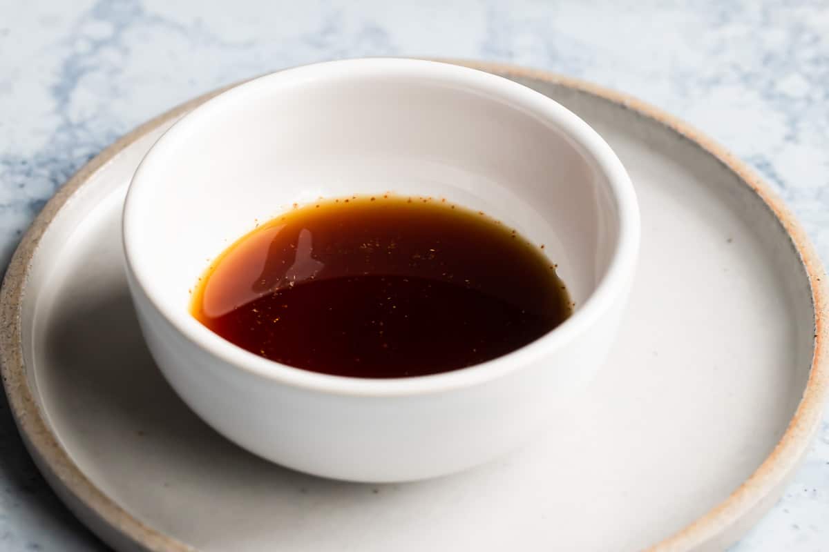 Ponzu sauce in a white dish.