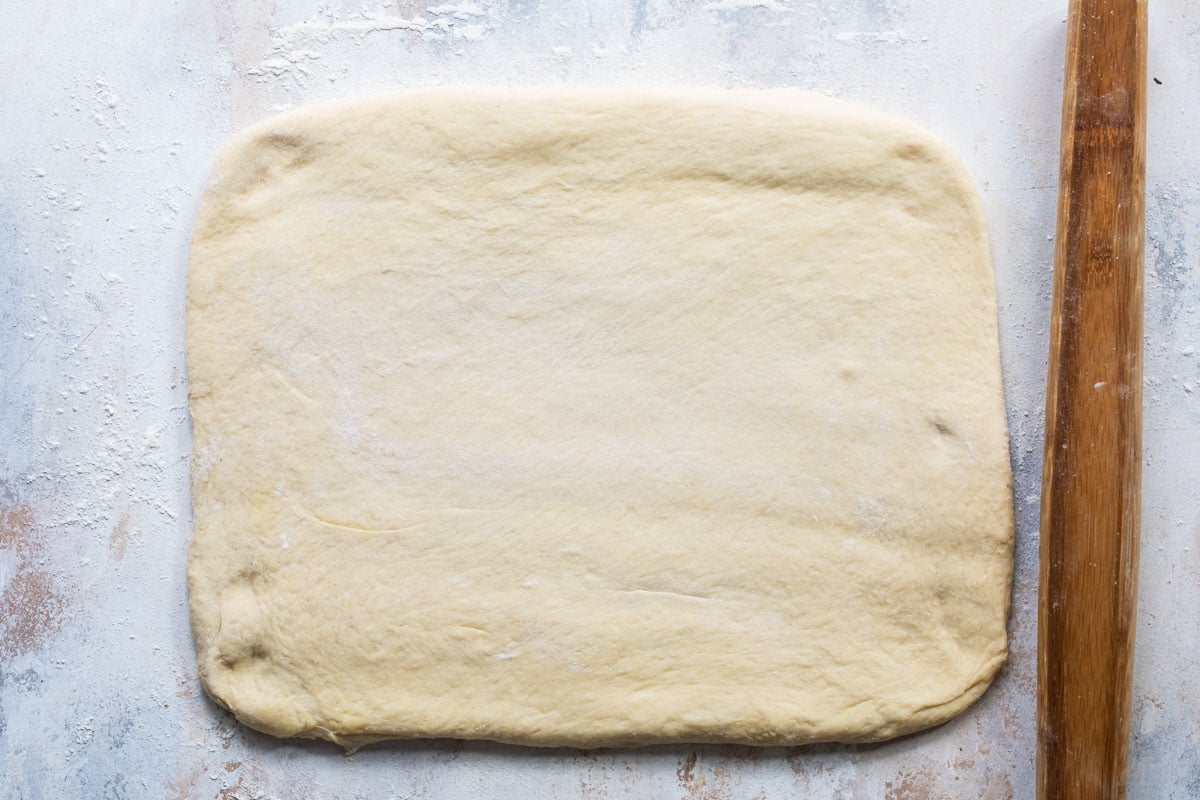 Dough rolled out on a countertop.