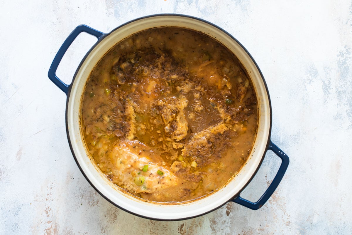 Chicken gumbo being cooked in a Dutch oven.