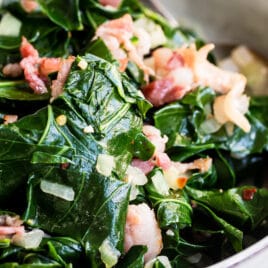 A bowl with collard greens in it.