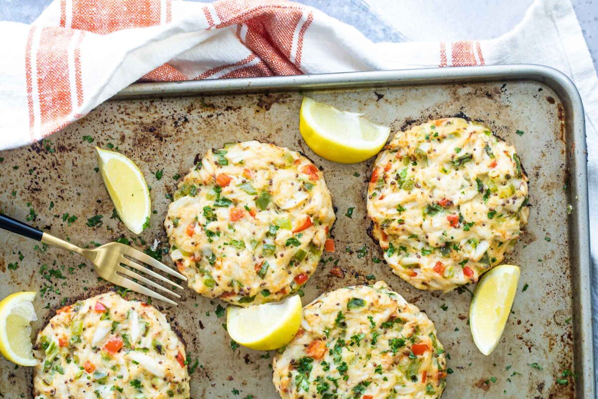 Crab cakes on a baking sheet after being in the oven.