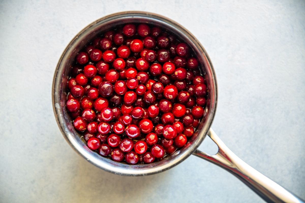Cranberries in a saucepan to make cranberry sauce.