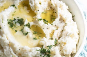 Make ahead mashed potatoes in a white bowl.