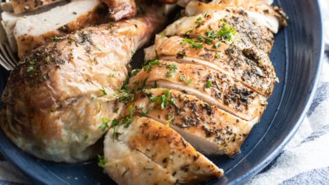 Make ahead roasted turkey on a blue platter.