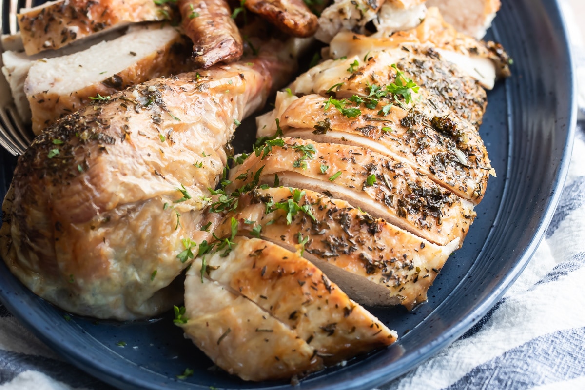 Make ahead roasted turkey on a blue platter.