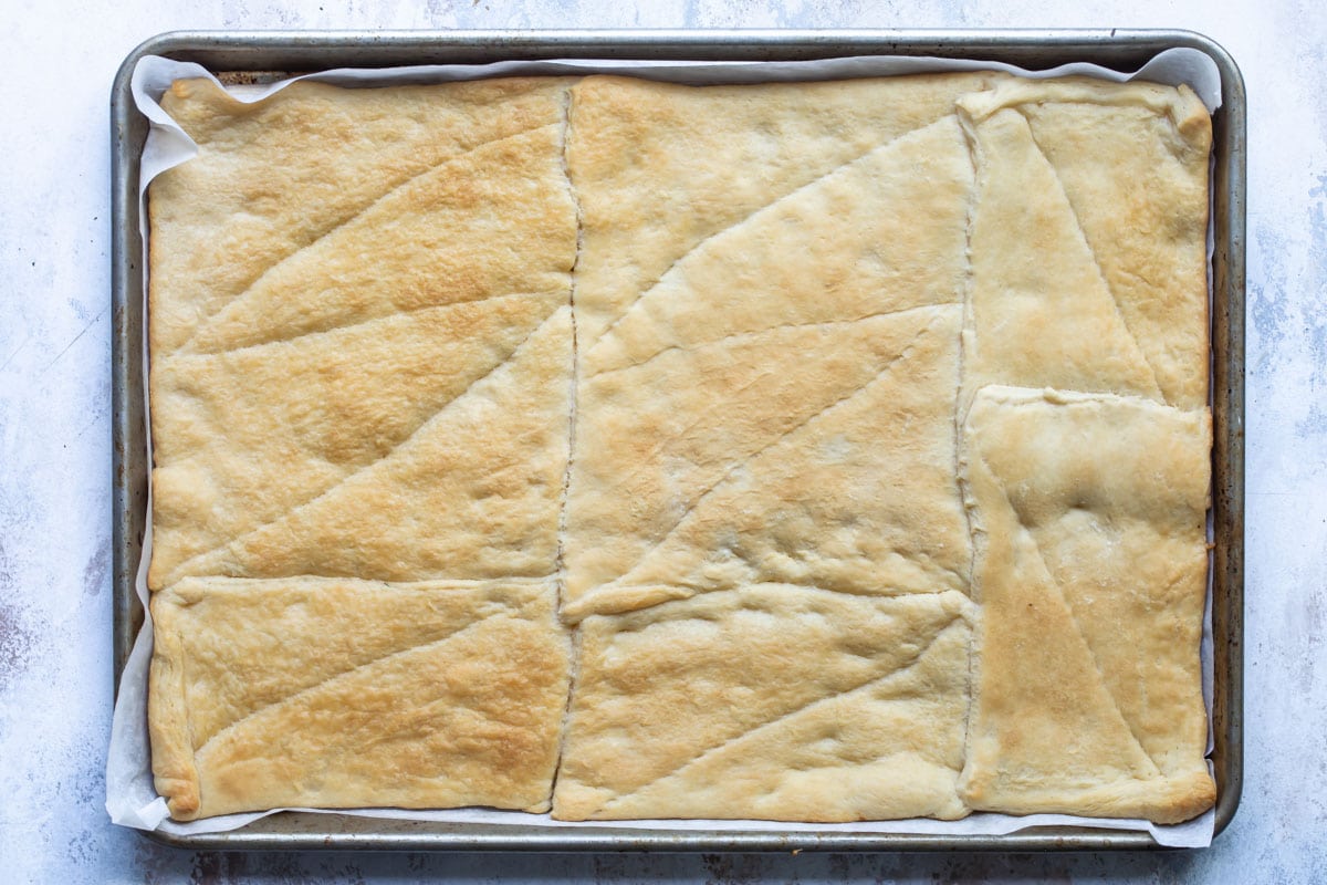 Crescent roll dough baked on a baking sheet.
