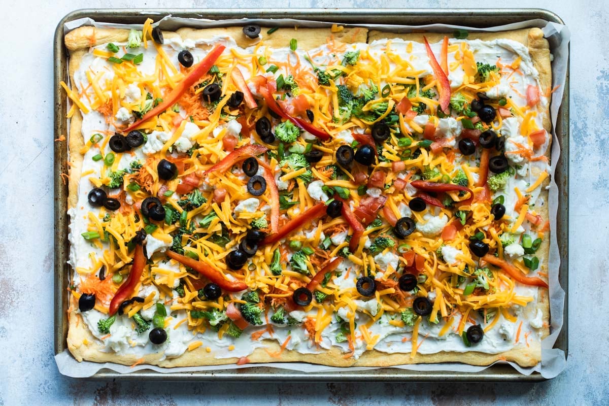 A completed veggie pizza on a baking sheet.
